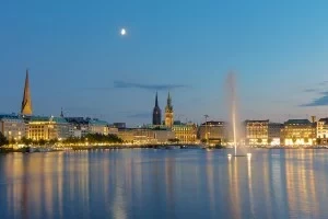 City skyline with fountain & lake in Germany